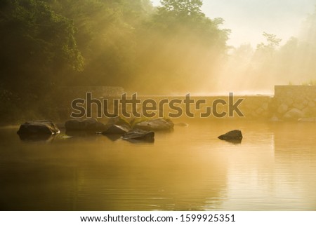 Distant mountains, deep forests and streams in the early morning mist in the gutters of jilin, China