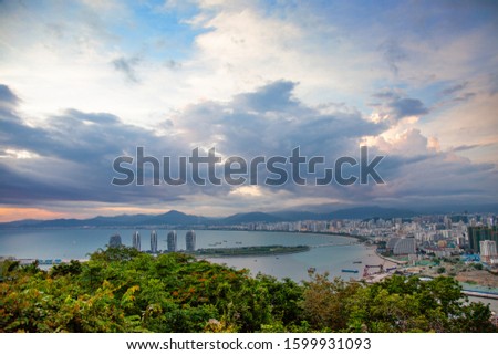 China Hainan Island Landscape Sunset View
Evening skyscrapers on the sea bay with blue clouds