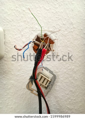 Colorful cables of a telephone connection socket in Germany are tested of a signal