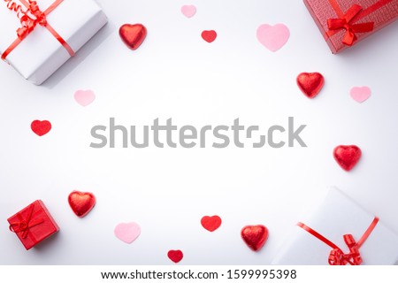 Valentine's Day background with gifts and hearts, in red and white, top view. San valentin and love concept.