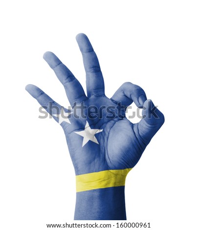 Hand making Ok sign, Curacao flag painted as symbol of best quality, positivity and success - isolated on white background