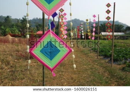 Karen hill tribe colorful mobile hanger  over village path in northern Thailand