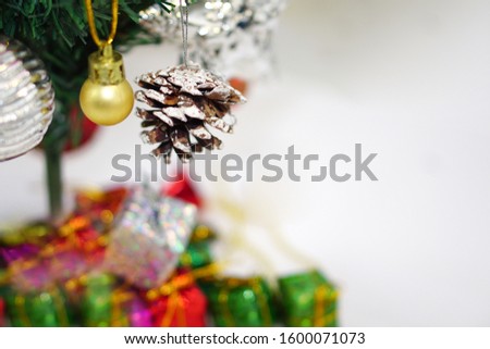 Christmas tree with decorated item hanging in a tree and gift box under the Christmas tree. Merry christmas, happy new year and greeting card concept.