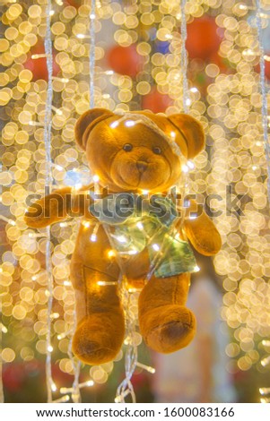 Toy bear on beautiful lighting bokeh background.