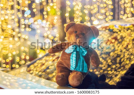 Toy bear on beautiful lighting bokeh background.
