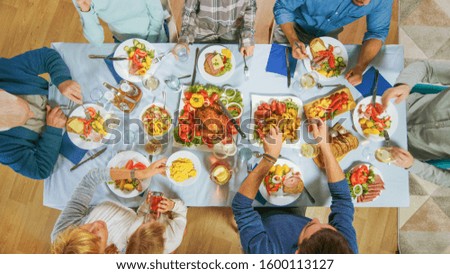 Top Down Shot. Big Family and Friends Celebration at Home, Diverse Group of People Gathered at the Table. Eating, Drinking, and Having Fun Conversations. Daytime Festivity.