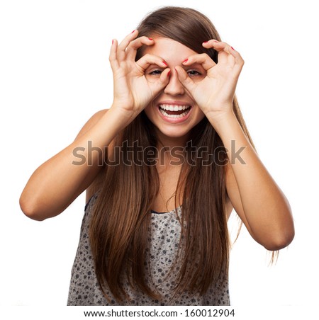 young girl doing glasses gesture isolated on white