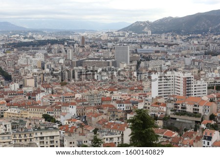 Panoramic view from notre dame de la garde church of Marseille city, Provence region, southern France. November, 20, 2019. Pattern of red roofs and streets. French Mediterranean cityscape. 