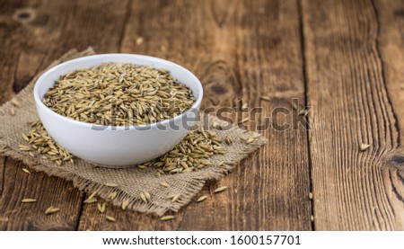 Wooden table with Oat (detailed close-up shot; selective focus)