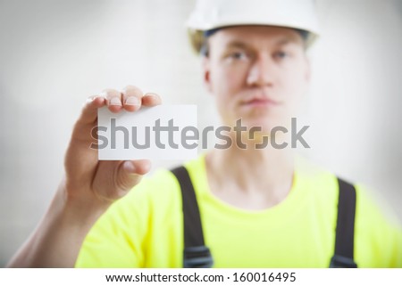 Construction worker holding business card