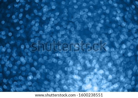 Color of the year 2020 Classic Blue . Classic blue glitter shiny background. Blurred christmas abstract texture. Bokeh
