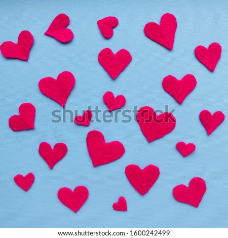 Valentine's day background.  red hearts on a pastel blue background.  symbol of love and valentines day concept.  pattern, flat lay, top view, copy space