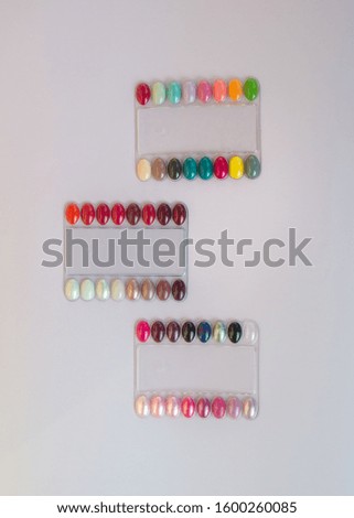 Multicolored nail polish samples, color palette in beauty salon. Manicure, fashion and stylish colors. Top view, flat lay

