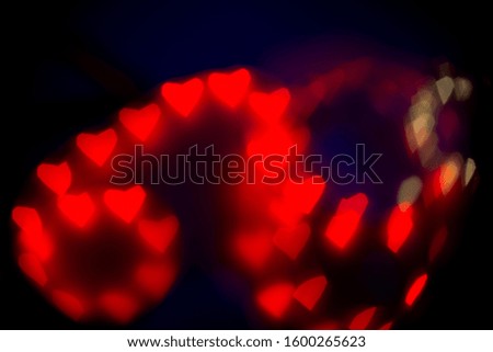Valentine's Day abstract background. Blurred bokeh with colorful hearts.