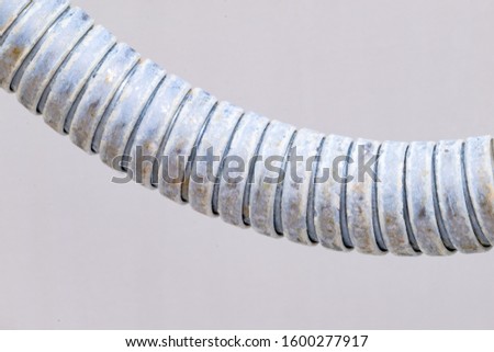 Close-up on shower hose with limescale. Calcification of a shower hose in bathroom.