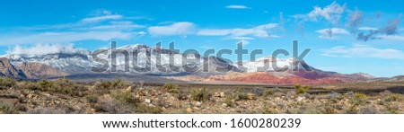 USA, Nevada, Clark County, Red Rock Canyon National Conservation Area. A panoroama of Snow covering the mountains above this famous hiking area outside Las Vegas Royalty-Free Stock Photo #1600280239