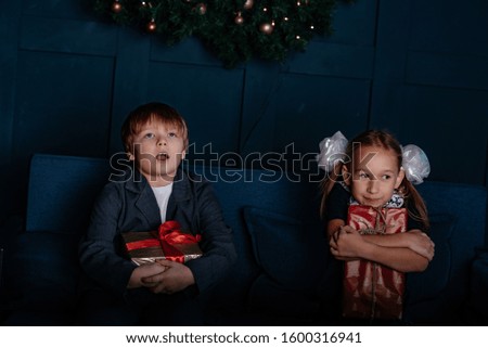 New Year and happy children. Boy and girl little their feast day. Toned photo.