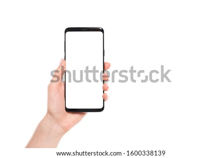 Woman hands holding the black smartphone blank screen with modern frameless design isolated on white background