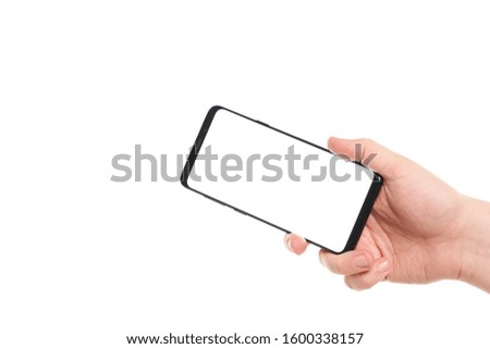 Man hand holding the black smartphone blank screen with modern frameless design isolated on white background