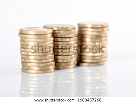A stack of Australian one dollar gold coins set against a white background.