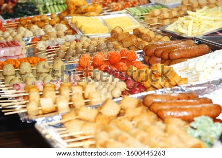 Delicious Asian cuisine/food on the night market. Traditional street food on the wooden skewers, various of sea food/meat.Photo taken at District 1 night market, Vietnam, Asia.