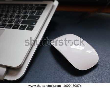 close up of mouse and laptop on the table