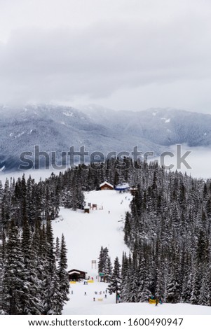 Whistler, British Columbia, Canada. Beautiful View of the Canadian Snow Covered Mountain Landscape during a cloudy and foggy winter day.