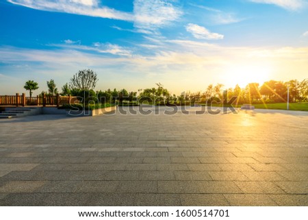 Empty square floors and beautiful sunset clouds in the city park.