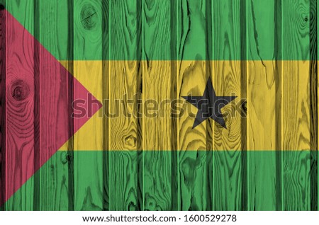 Sao Tome and Principe flag depicted in bright paint colors on old wooden wall. Textured banner on rough background