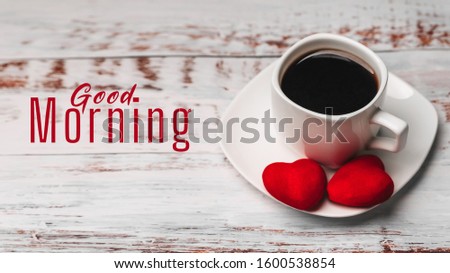 Greeting card with the inscription Good morning. A Cup of coffee with red hearts on a white wooden table