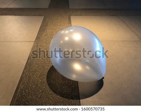 Balloon on the floor, tile, balloon, cross.