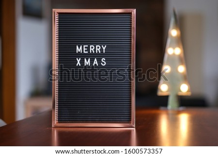 A vertical selective focus shot of a festive board and lights spreading a cheerful atmosphere