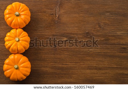 Autumn pumpkins on wooden board 