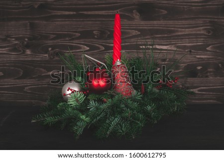 natural table Christmas decoration with candle and beads in the glass