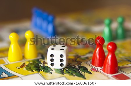 colorful play figures with dice on board Royalty-Free Stock Photo #160061507