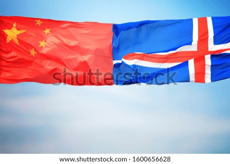 Chinese and Icelandic flags amid blue skies