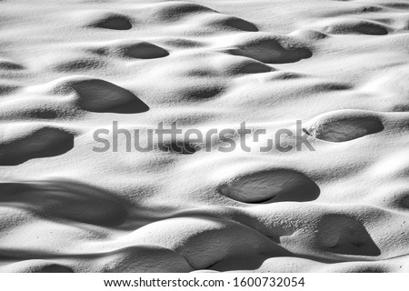 Snow on rocks on a winter hillside.