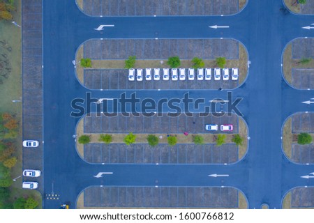 In rainy days and cold colors, aerial photos of white electric vehicles parked in the parking lot 2