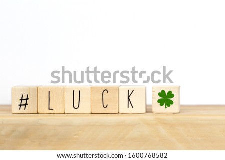 Wooden cubes with a hashtag and the word lucky background, social media concept close-up