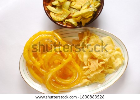 India sweets and savoury - Jalebi and Fafda on white plain background. Popular vegetarian festive snacks with Indian Gujarathi community. Both these food articles always go together.