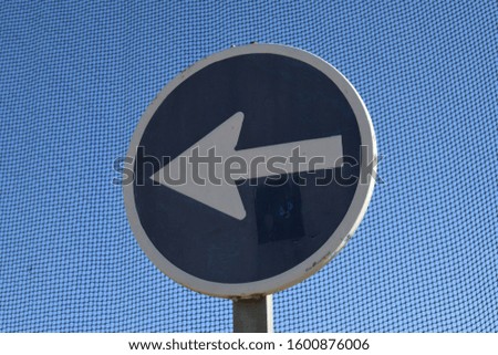 a traffic sign: "prescribed direction of travel on the left", Alicante Province, Costa Blanca, Spain