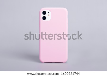 Pink phone case mockup. iPhone 11 mock up back view isolated on gray background Royalty-Free Stock Photo #1600921744