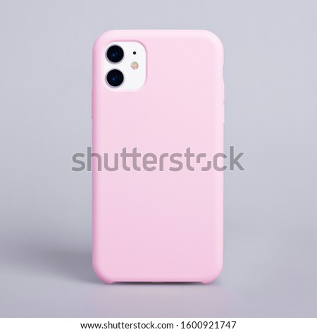 Phone case mockup. iPhone 11 smartphone back view in pink cover isolated on gray background