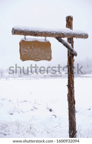 Signboard on the snowy scene