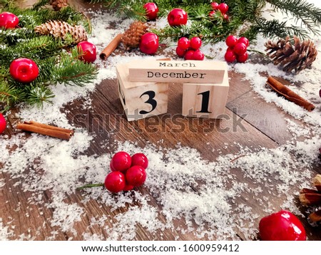 New Year Card with Pine Branches and Wooden Calendar with 31 of December Date .New Year Concept