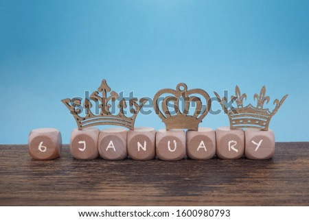 Epiphany, symbolized by tinkered crowns wooden background, Three King's Day