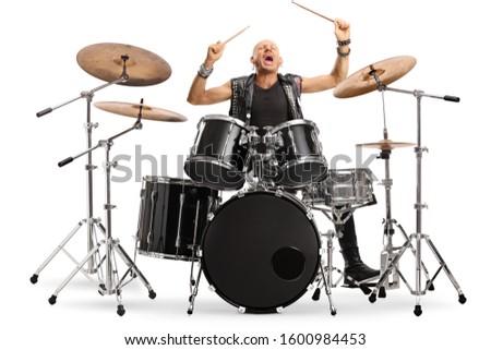 Male musician in leather vest playing a drum kit isolated on white background Royalty-Free Stock Photo #1600984453