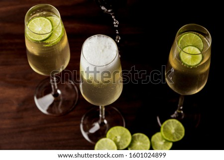 Champagne cocktails. Traditional American craft cocktails made by artisanal bartenders or mixologists in speakeasy & upscale bars or dive bar taverns. Cocktails served in chilled cocktail glasses.