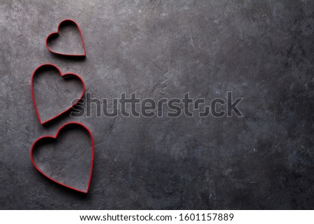 Valentines day heart shaped gingerbread cookies form over stone background with copy space for your greetings. Top view flat lay