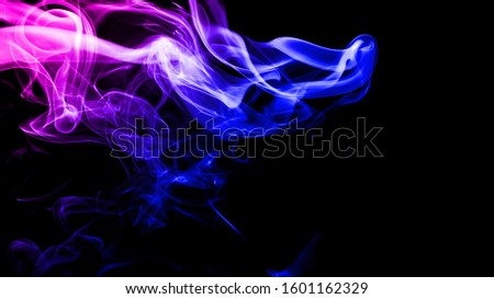 Colorful clouds of smoke on a black background. Abstract dark background